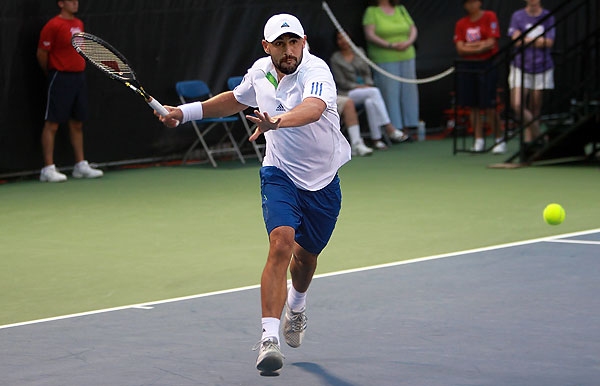 Marcos Falls To Isner In Opener